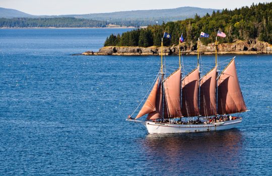 "Bar Harbor, Maine, USA - September 11, 2012: The four masted schooner Margaret Todd sails a group of tourists across the waters of Frenchman's Bay off the coast of Bar Harbor, Maine. The small objects scattered on the water surface are bouys marking the location of lobster traps."